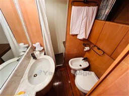 Bathroom interior of 1996 Sanlorenzo 62 yacht with sink, toilet, and bidet.