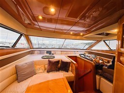 Luxurious interior of a 1996 Sanlorenzo 62 yacht with plush seating and panoramic windows.