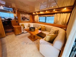 Luxurious interior of a 1996 Sanlorenzo 62 yacht with elegant seating and wooden accents.