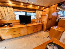 Luxurious interior of a 1996 Sanlorenzo 62 yacht with wood finishes and modern amenities.