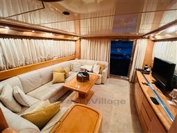 Luxurious interior of a 1996 Sanlorenzo 62 yacht with elegant seating and decor.