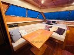 Luxurious interior of 1996 Sanlorenzo 62 yacht with elegant seating and wooden table.
