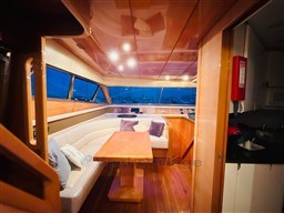 Luxurious interior of 1996 Sanlorenzo 62 yacht with elegant seating and wooden finishes.