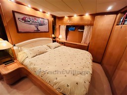 Luxurious bedroom interior of 1996 Sanlorenzo 62 yacht with elegant decor and ambient lighting.