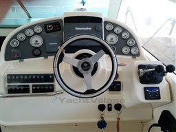 Control panel of a 2005 Jeanneau Prestige 34 S boat with steering wheel and gauges.