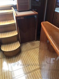 Interior of 2005 Jeanneau Prestige 34 S yacht with wooden flooring and steps.