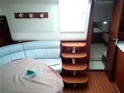 Interior of 2005 Jeanneau Prestige 34 S yacht with seating and wooden steps.