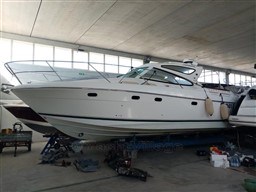 2005 Jeanneau Prestige 34 S yacht in indoor storage, side view.