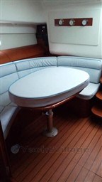 2005 Jeanneau Prestige 34 S yacht interior with oval table and cushioned seating.