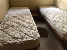Twin beds in the cabin of a 2005 Jeanneau Prestige 34 S yacht.