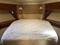 Luxurious cabin interior of 2005 Jeanneau Prestige 34 S yacht with cozy bed.