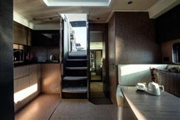 Interior of 2025 Azimut Atlantis 45 yacht, featuring modern kitchen and cozy seating area.