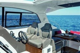 2025 Azimut Atlantis 45 yacht interior with ocean view, featuring modern seating and dining area.