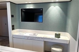 Modern interior of 2024 Sanlorenzo SL120 A yacht with TV and sleek furnishings.