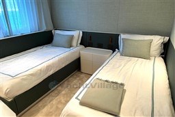 Luxurious twin bedroom in 2024 Sanlorenzo SL120 A yacht, featuring elegant bedding and modern design.