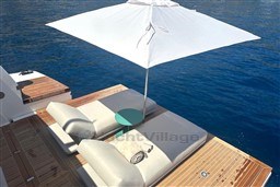 Luxury sun deck on 2024 Sanlorenzo SL120 A yacht with umbrella and loungers.