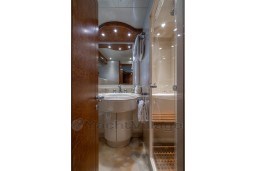 Luxurious bathroom interior of 1999 Mangusta 105 Sport yacht with elegant fixtures.