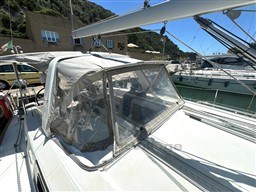 Beneteau Oceanis 38.1 sailboat, 2021 model, docked with protective canopy, sunny marina setting.