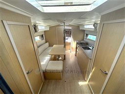 Interior of 2021 Beneteau Oceanis 38.1 yacht, featuring modern kitchen and seating area.