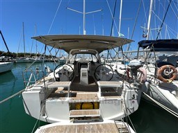 Beneteau Oceanis 38.1 sailboat, 2021 model, docked in a marina under clear blue skies.