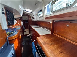 Interior of 2001 Beneteau Oceanis 40 CC sailboat with wooden cabinetry and compact kitchen.