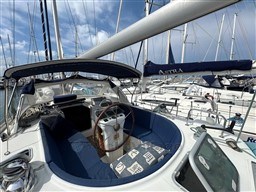 Beneteau Oceanis 40 CC sailboat cockpit, 2001 model, docked in a marina under blue skies.