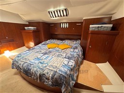 Luxurious cabin interior of 2001 Beneteau Oceanis 40 CC sailboat with cozy bedding.