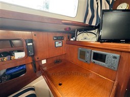 Navigation station on 2001 Beneteau Oceanis 40 CC yacht with communication equipment and wooden finish.