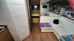 Interior of 2013 Rio Yachts Rio 36, featuring white seating and wooden flooring.