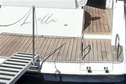 Rear deck of 2013 Rio Yachts Rio 36 with wooden flooring and metal railings.