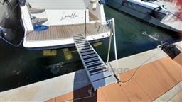 Rio Yachts Rio 36, 2013 model, docked with gangway extended over water.