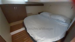 Cozy bedroom in 2013 Rio Yachts Rio 36, featuring a double bed and wooden cabinetry.