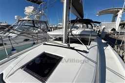 2024 Dufour 37 sailboat docked at marina under clear blue sky.