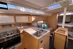 Interior of 2024 Dufour 37 yacht with modern kitchen and cozy seating area.