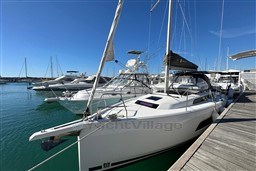 2024 Dufour 37 sailboat docked in a marina under clear blue skies.