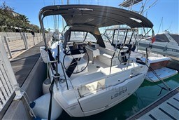 2024 Dufour 37 sailboat docked at marina, featuring spacious cockpit and modern design.