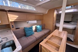 2024 Dufour 37 yacht interior with modern wood finish, cozy seating, and natural light.
