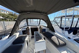 2024 Dufour 37 yacht cockpit with seating and canopy, docked at marina.