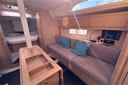 2024 Dufour 37 yacht interior with cozy seating, cushions, and modern design.