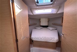 2024 Dufour 37 yacht cabin with cozy bed and natural wood finish.