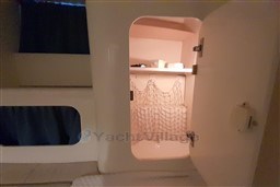 Interior storage compartment on 2002 Cranchi Smeraldo 37 yacht, featuring shelves and netting.