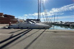 2002 Cranchi Smeraldo 37 yacht docked in a sunny marina.