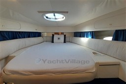 Luxurious cabin interior of 2002 Cranchi Smeraldo 37 yacht with spacious bed.