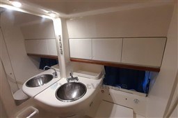 Bathroom interior of 2002 Cranchi Smeraldo 37 yacht with stainless steel sink.