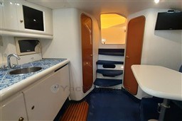 Interior of 2002 Cranchi Smeraldo 37 yacht with kitchenette and seating area.