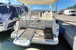 2002 Cranchi Smeraldo 37 yacht docked, featuring spacious deck and boarding platform.