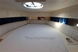 Interior cabin of 2002 Cranchi Smeraldo 37 yacht with circular bed and porthole.