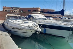 2002 Cranchi Smeraldo 37 yacht docked in a marina under clear skies.