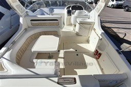 2002 Cranchi Smeraldo 37 yacht interior with seating, table, and helm station.