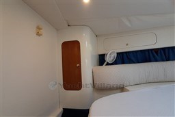 Interior cabin of 2002 Cranchi Smeraldo 37 yacht with cozy seating and storage.
